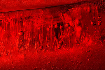 Air bubbles in red ice. Abstract background