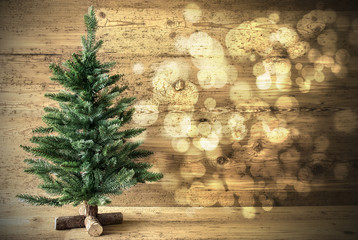 green christmas tree on wooden background, lights