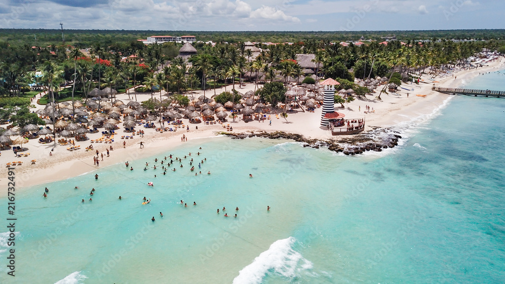 Beautiful Beach at a resort in the Caribbean. View of the beach and the lighthouse. Aerial view - obrazy, fototapety, plakaty 