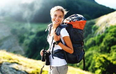 Woman with backpack trekking through the wilderness