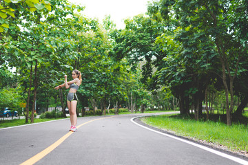 Pretty sporty woman jogging at park in sunrise light