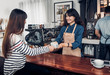© weedezign - Barista served hot coffee cup to customer with smile face at counter bar in cafe restaurant,coffee shop business owner concept,Service mind waitress.