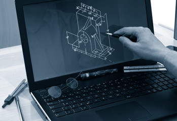 Wall Mural - engineer working at computer laptop on cad mechanical piece design