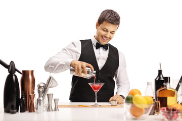 Poster - Barman pouring his signature cocktail in a glass