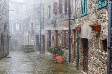 Canvas Print - Misty alley in an Italian village