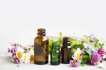 Wall Mural - Flowers and herbs essential oil bottles, natural aromatherapy with oils and essences