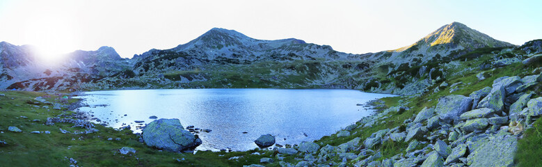 Mountain panorama with peaks and glacial lake at sunset, Carpathian Mountains