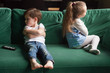 © fizkes - Upset siblings boy and girl sulking sitting with arms crossed on sofa not talking, kids brother sister ignoring each other after fight about tv channel choice, children conflicts and rivalry concept