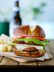 Wall Mural - vegan cheese burger on pretzal bun and meatless bacon