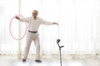 © IndiaPix - Senior man exercising with hoopla hoop