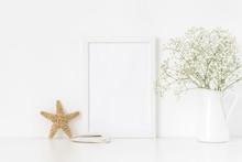White Frame Mockup A4 In Interior With Sea Elements . Frame Mock Up Background For Poster Or Photo Frame For Bloggers, Social Media, Lettering, Art And Design. Indoor, Frame On Table With Flowers In
