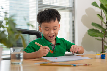 Hands of painting little boy and the table for creativity