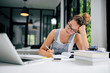 © bnenin - Portrait of a college girl with hand holding her head while studying.