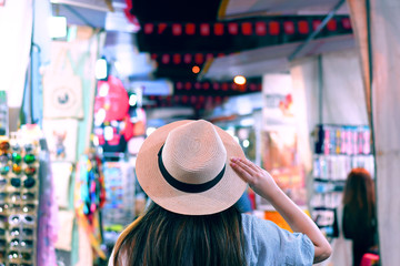 Tourist is enjoy traveling in famous night market in Mong Kok, Hong Kong.