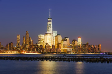 Fototapete - Lower Manhattan skycrapers illuminated at twilight with the Hudson River. Manhattan, New York City