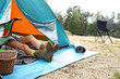 © New Africa - Young woman resting in camping tent on summer day