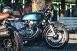 © Sergey - two classic style cafe racer motorcycle at sunset time. Bike custom made in vintage. Brutal fun urban lifestyle