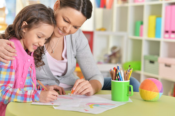 Sticker - Portrait of mother and daughter sitting at table