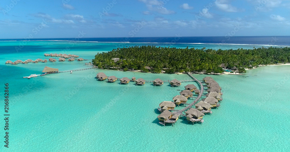 Water bungalows resort at islands, french polynesia in aerial view - obrazy, fototapety, plakaty 