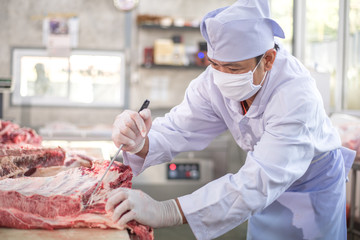 Butcher working in meat industry factory good product of food