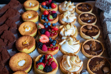 Assortment Of Delicious And Colorful Dessert, Chocolate Cakes, Mixed Berry Tarts, Lemon Meringue Tarts, Chocolate Tarts Made By Pastry Chef. All Look Very Tasty And Delightful. Natural Light.
