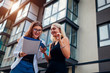 © maryviolet - Real estate agent presenting new apartment to client. Businesswoman shows contract to customer. Partners laughing