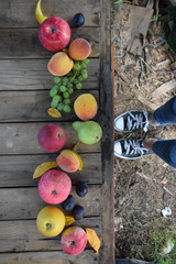 Wall Mural - Sneakers on the background of fruits and autumn leaves