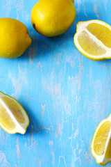 Sticker - Fresh lemons on blue wooden background