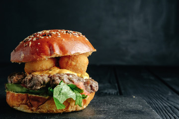 homemade  juicy burger on dark wooden board. Street food, fast food.