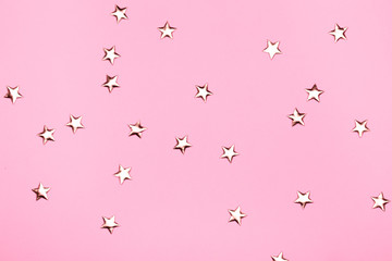 Wall Mural - Golden stars glitter on pink background.