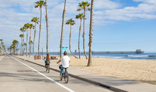 People Riding Bikes At Beach