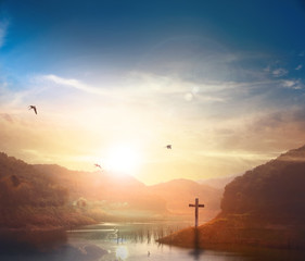 Wall Mural - Christ Jesus birth and resurrection concept :Silhouette cross on Calvary mountain sunset background