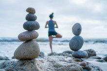 Beautiful Girl Tree Pose Yoga By The Ocean With Stacking Rocks 