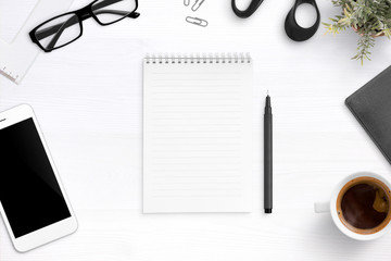 Aufkleber - Blank notebook on office desk surrounded with pen, glasses, cup of coffee, mobile phone. Flat lay, top view.