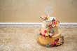 Close-up view from above of a large wedding three-story cream cake. The idea of decorating wedding deseres, decoration with flowers.