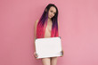 Beautiful young woman holding a blank sheet of paper. Space for your text. on pink. Modest young naked student with a white writing Board marker covers her naked body.