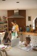 © Wavebreak Media - Girl  with family using laptop in kitchen