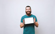 © Vulp - Cheerful bearded man showing blank screen on tablet