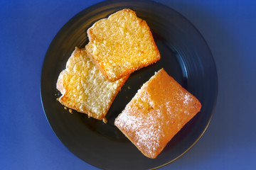 delicious fresh cupcake on a plate on a blue background