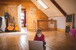 © Wavebreak Media - Boy using laptop while sitting on wooden floor at home