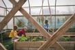 © Wavebreak Media - Kids helping mother in greenhouse plantation