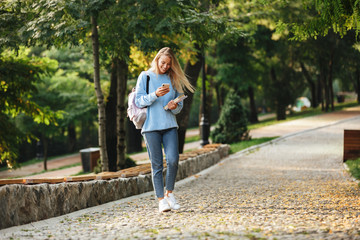 Poster - Portrait of a pretty young girl student with backpack