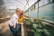 © Wavebreak Media - Mother and son gardening in greenhouse