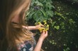 © Wavebreak Media - Girl holding flower in hand at greenhouse