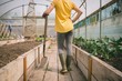 © Wavebreak Media - Woman with digging fork standing in greenhouse