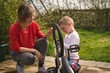© Wavebreak Media - Mother and son repairing bicycle together