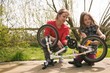 © Wavebreak Media - Mother and daughter repairing bicycle at backyard