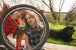 © Wavebreak Media - Mother and daughter repairing bicycle together