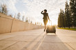 © mnelen.com - slender young female flight attendant in uniform with a suitcase goes on her flight