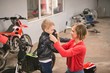 © Wavebreak Media - Mother preparing her son for bike riding